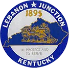 City Seal: Goldenrod yellow steam engine sits inside the outline of the state of KY with '1895' above it and 'To Protect and To Serve' below it, all surrounded by a blue circle with 'Lebanon Junction Kentucky' written along the outside