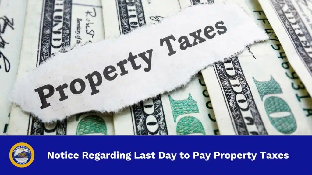 Ripped piece of paper that reads "Property Taxes" sitting on top of $100 bills